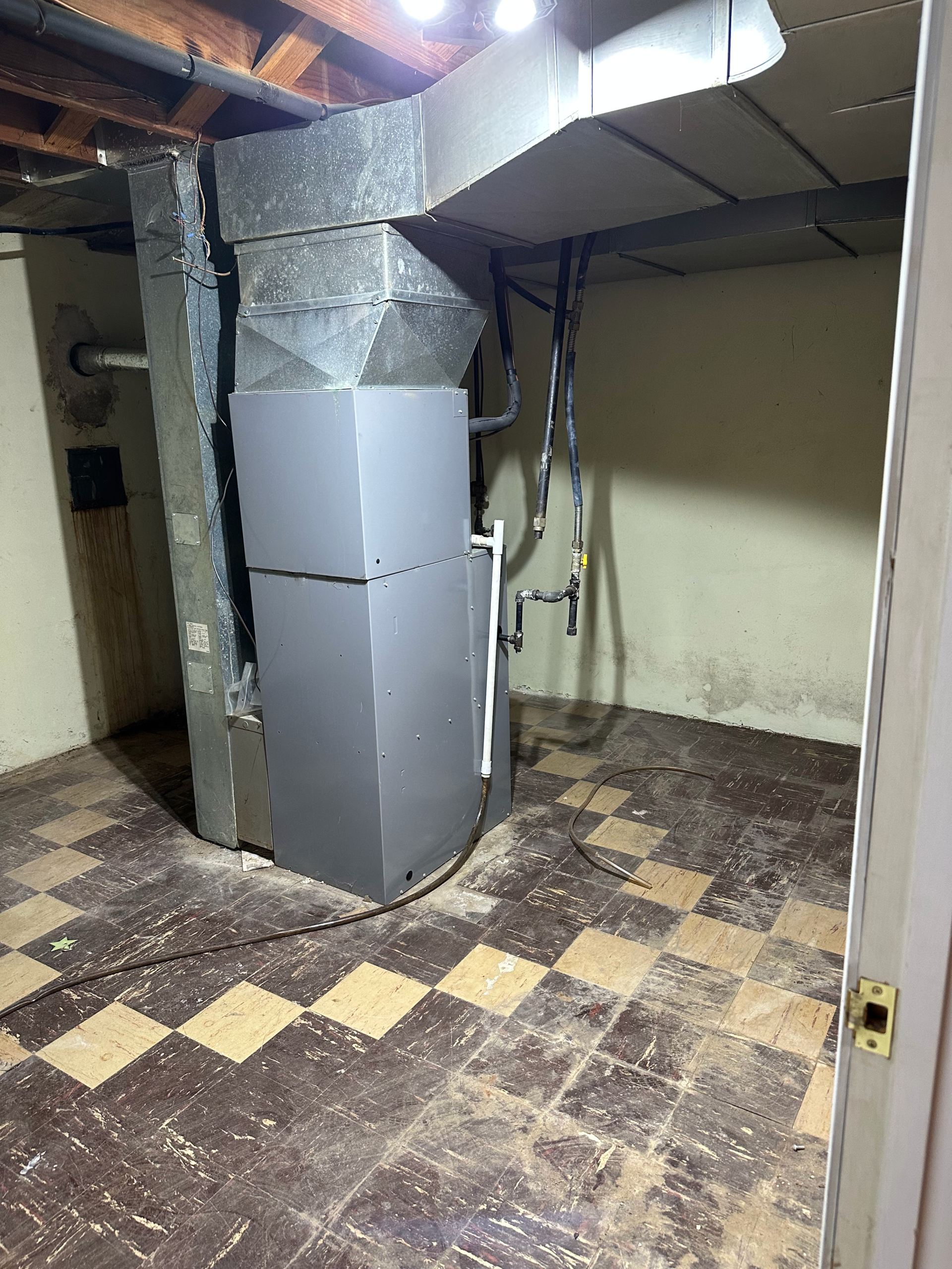 hauling away an old air conditioner unit during HVAC replacement and junk removal service in Troy, Missouri