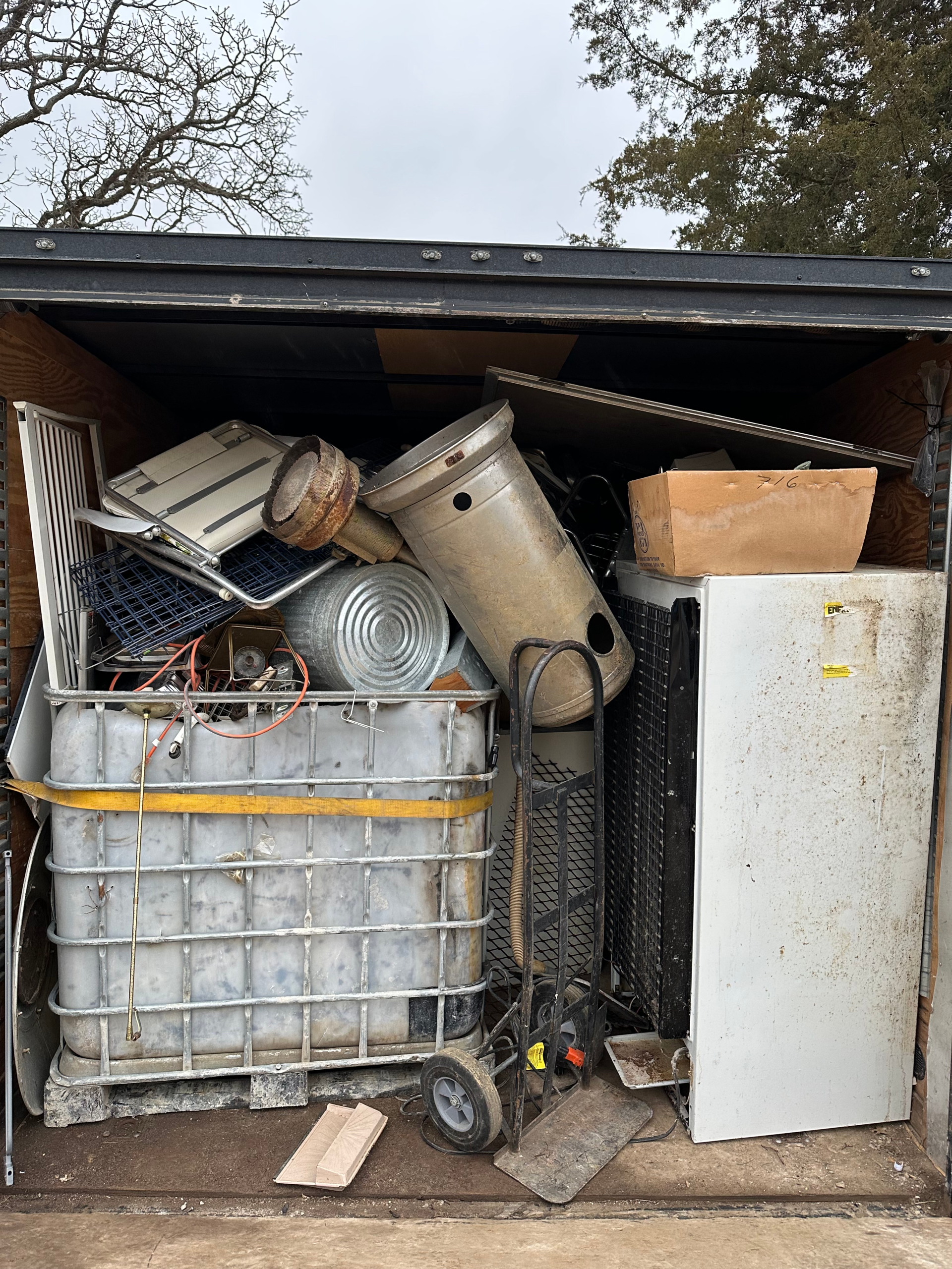 Appliance removal service hauling refrigerator and other large appliances.