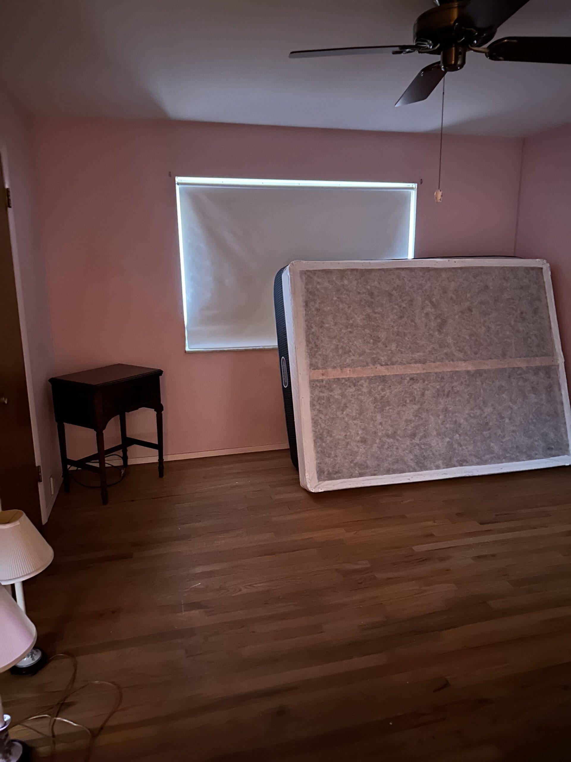 Mattress propped against a wall inside a room, ready for pickup by a professional mattress removal service in Troy, Missouri.